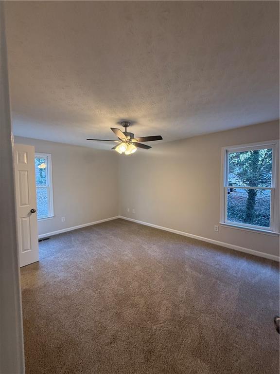 290 Mill Pointe Trail Dallas, GA 30157 - Photo 4 of 8 an empty room with a empty space and a ceiling fan