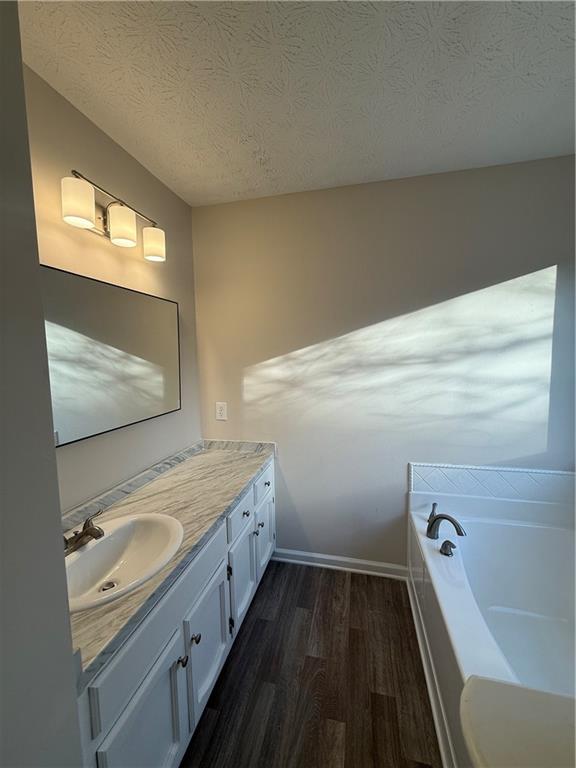 290 Mill Pointe Trail Dallas, GA 30157 - Photo 7 of 8 a bathroom with a double vanity sink a toilet and bathtub