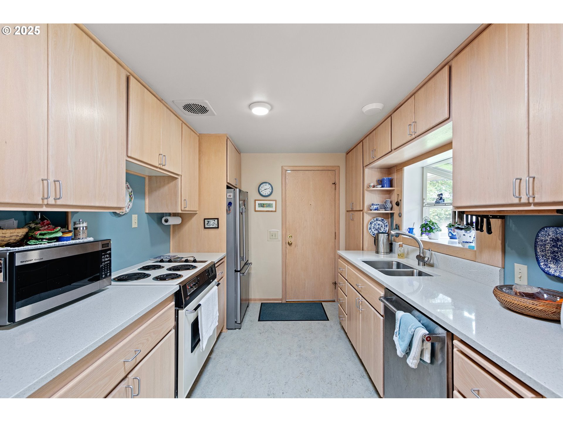 3175 Potter Street Eugene, OR 97405 - Photo 13 of 45 a kitchen with stainless steel appliances a sink stove and refrigerator