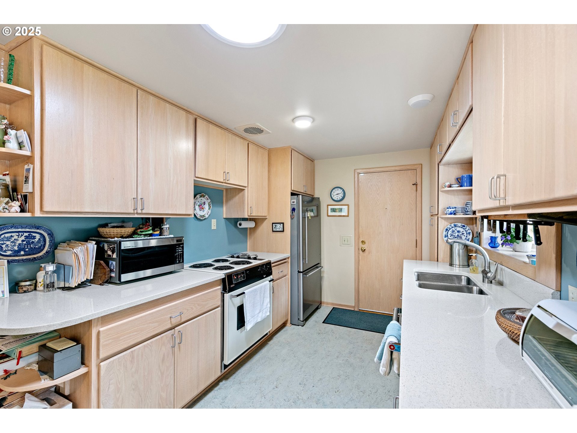 3175 Potter Street Eugene, OR 97405 - Photo 14 of 45 a kitchen with stainless steel appliances granite countertop a refrigerator a stove a sink dishwasher and white cabinets with wooden floor