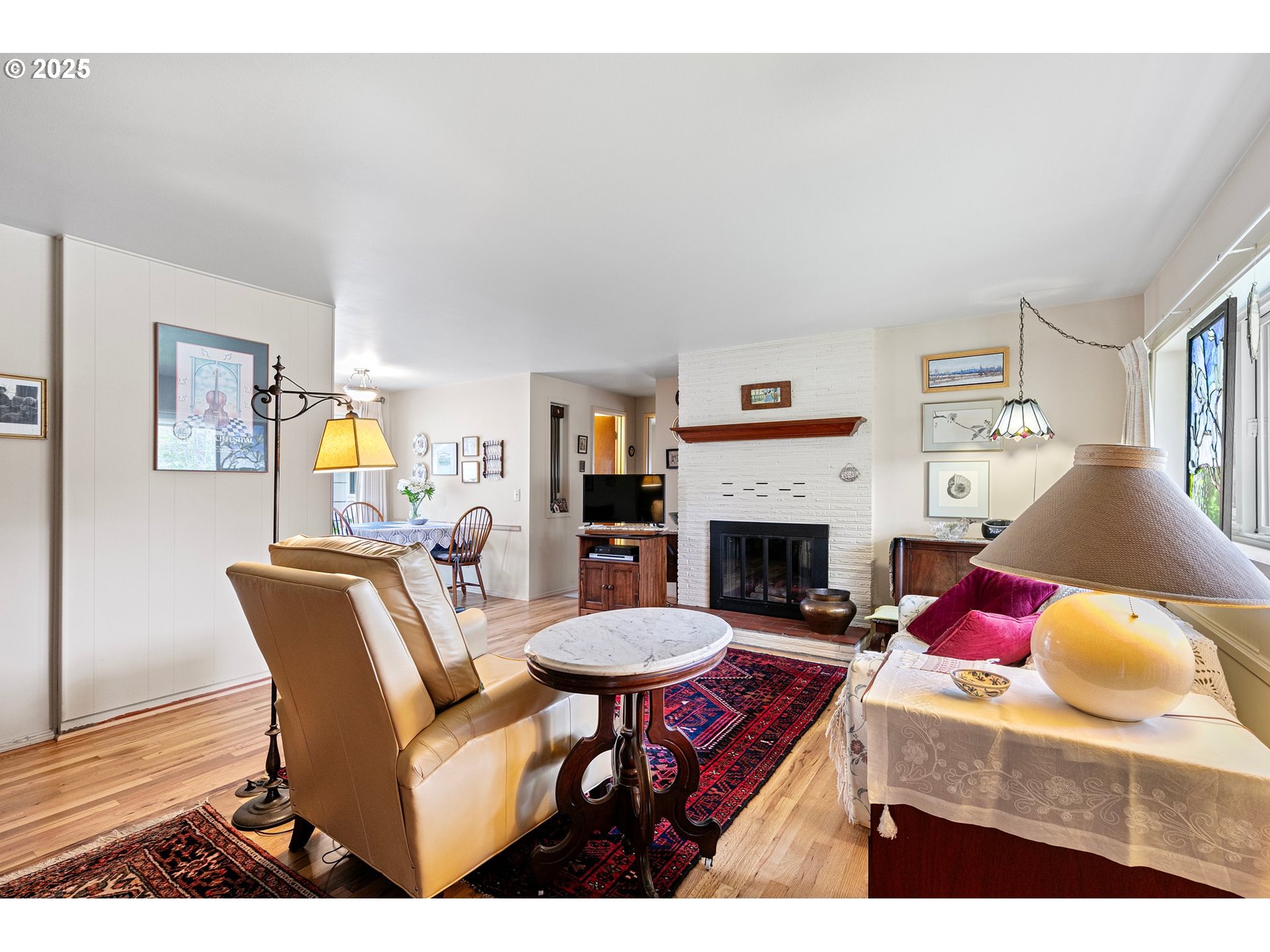 3175 Potter Street Eugene, OR 97405 - Photo 7 of 45 a living room with furniture a fireplace and a large window