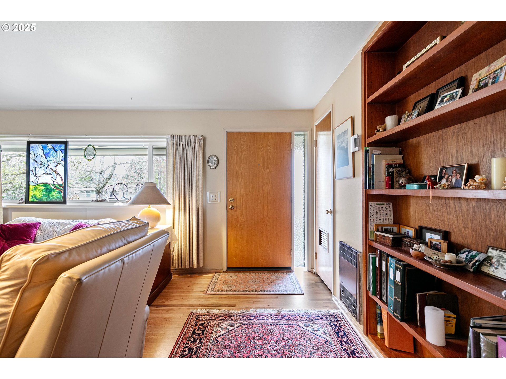 3175 Potter Street Eugene, OR 97405 - Photo 9 of 45 a living room with a couch bookshelf and a window