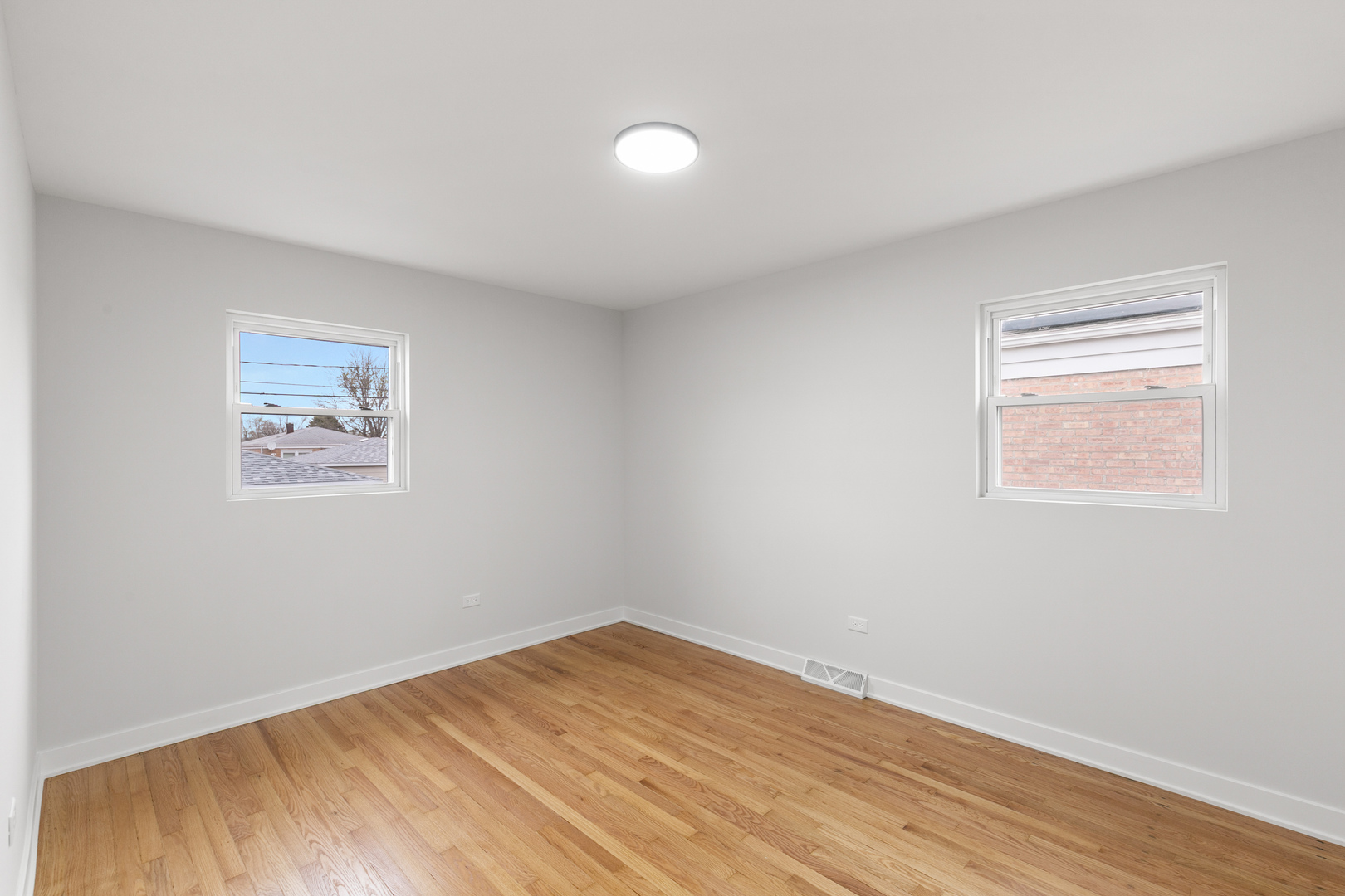 1042 West 109th Place Chicago, IL 60643 - Photo 14 of 24 a view of a room with wooden floor and white walls