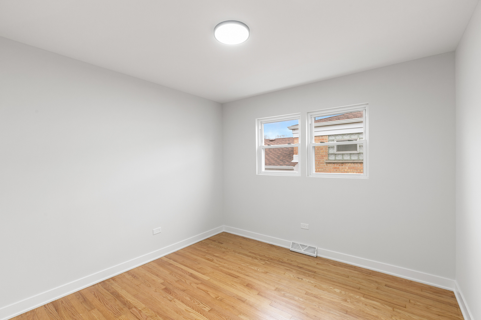 1042 West 109th Place Chicago, IL 60643 - Photo 15 of 24 an empty room with wooden floor and windows
