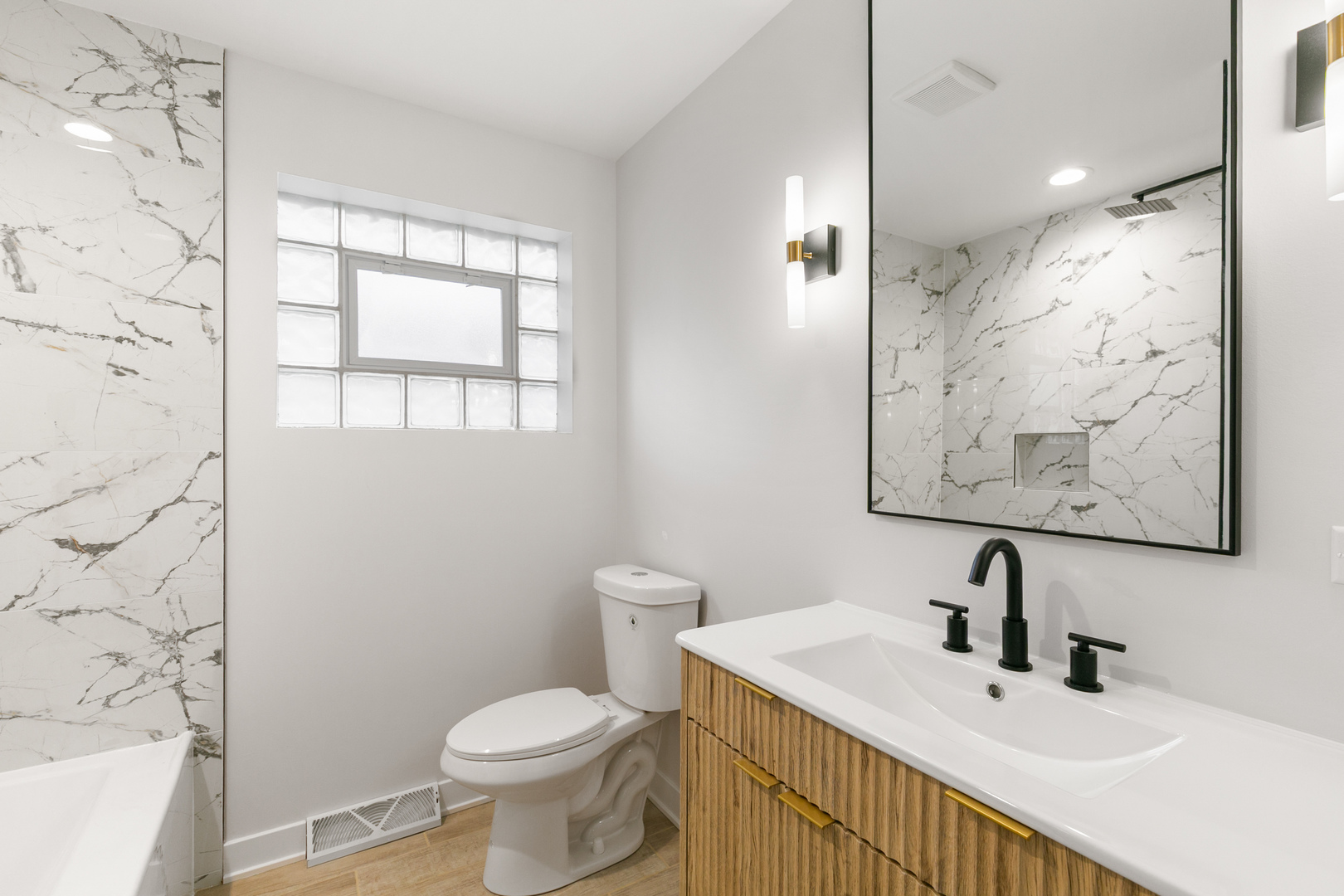 1042 West 109th Place Chicago, IL 60643 - Photo 17 of 24 a bathroom with a toilet sink and mirror