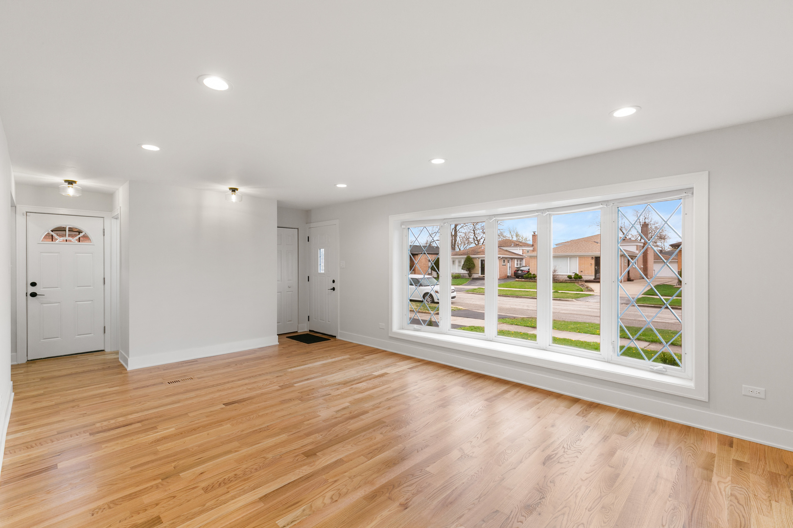 1042 West 109th Place Chicago, IL 60643 - Photo 3 of 24 an empty room with wooden floor and windows