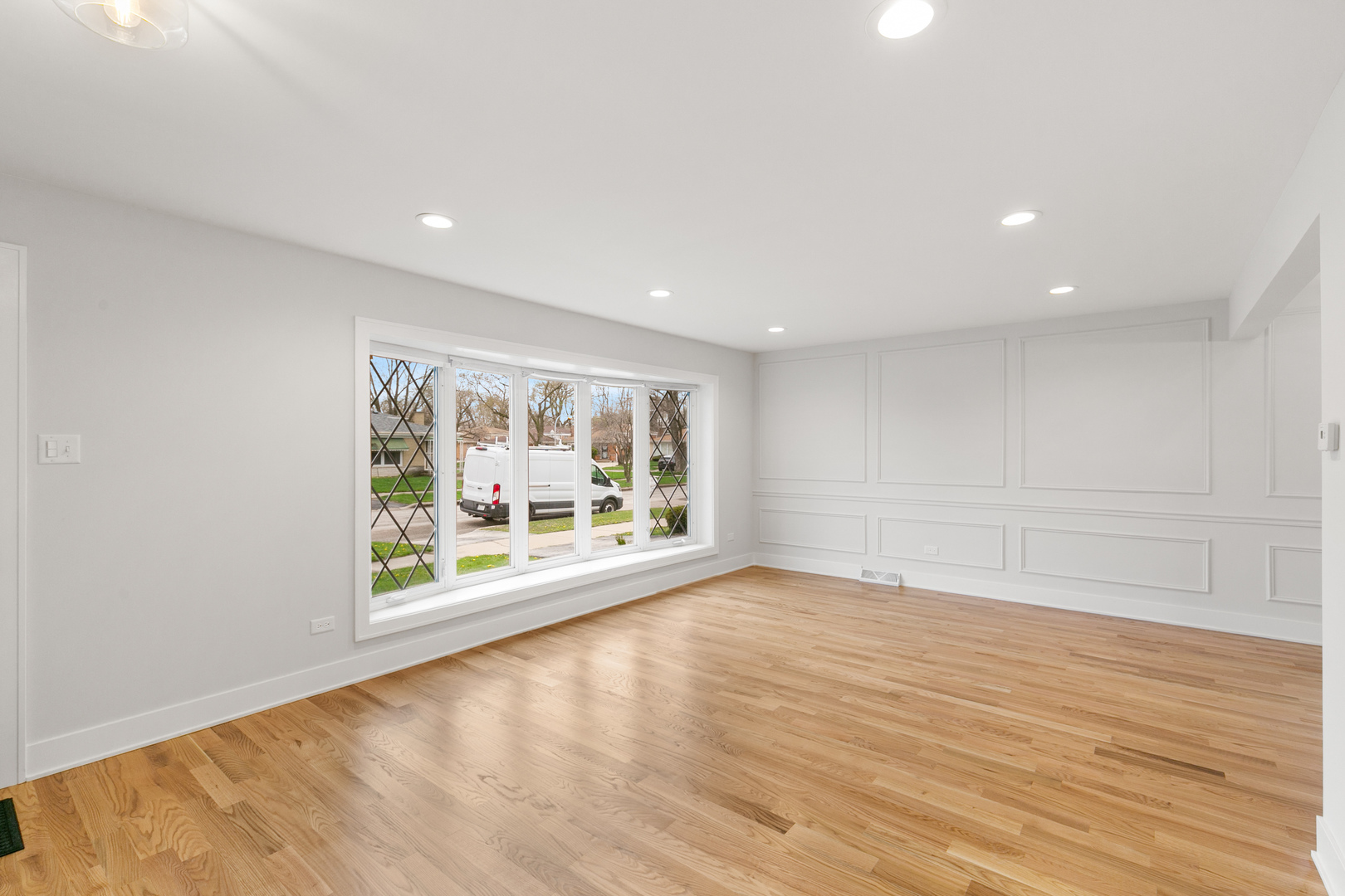 1042 West 109th Place Chicago, IL 60643 - Photo 4 of 24 a view of an empty room with wooden floor and a window