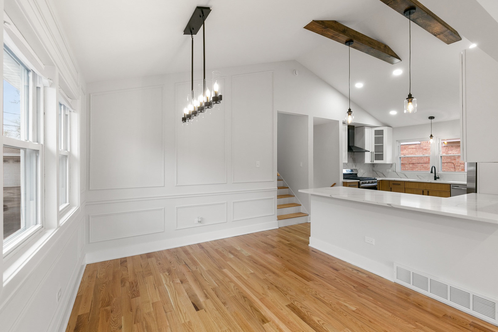 1042 West 109th Place Chicago, IL 60643 - Photo 7 of 24 a view of a kitchen with kitchen island a sink wooden floor and stainless steel appliances