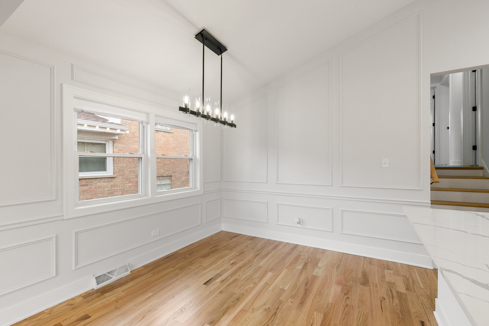 1042 West 109th Place Chicago, IL 60643 - Photo 8 of 24 a view of empty room with wooden floor and fan
