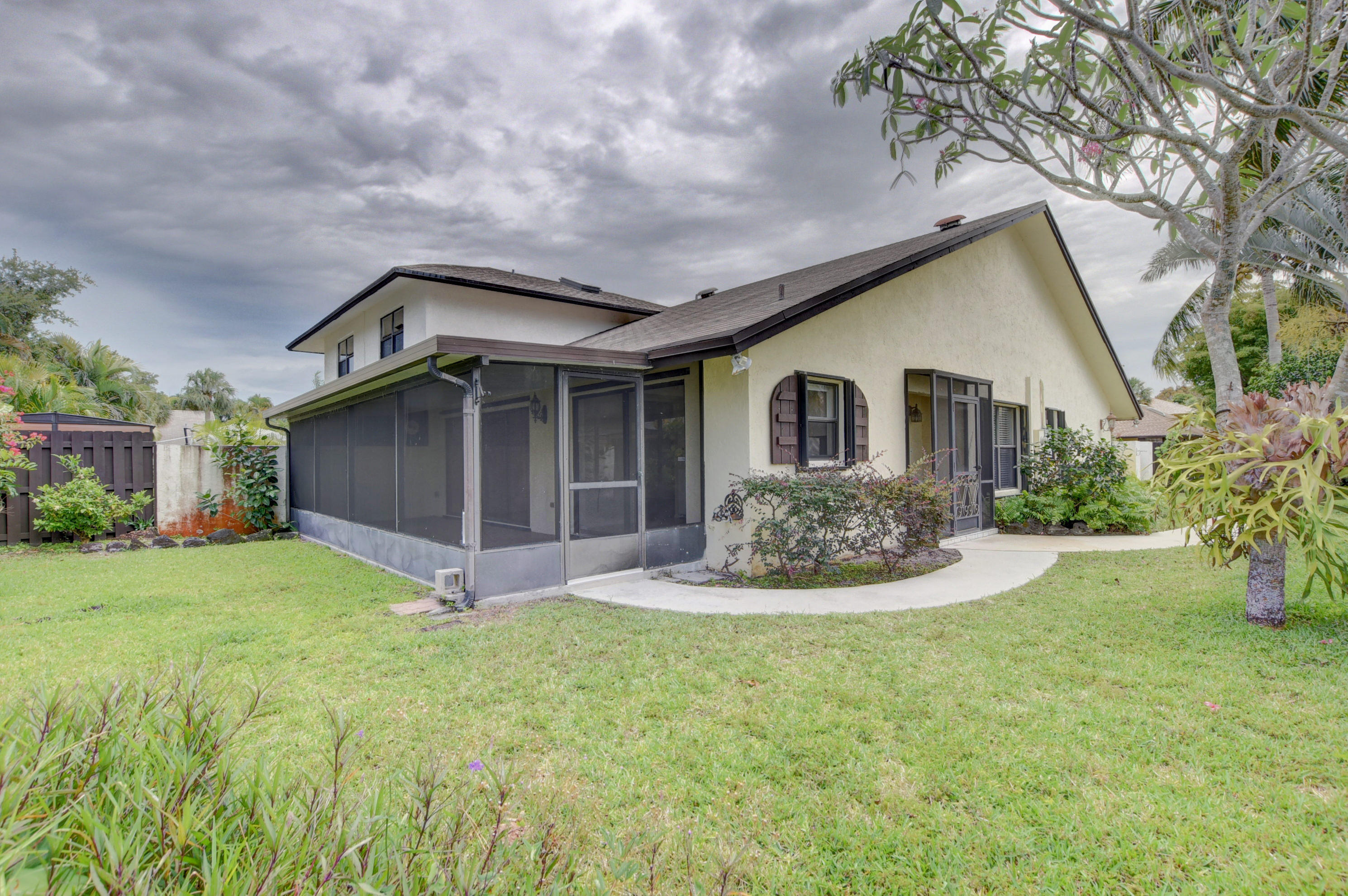 569 Southwest 28th Avenue Delray Beach, FL 33445 - Photo 1 of 25 a front view of house with yard and green space