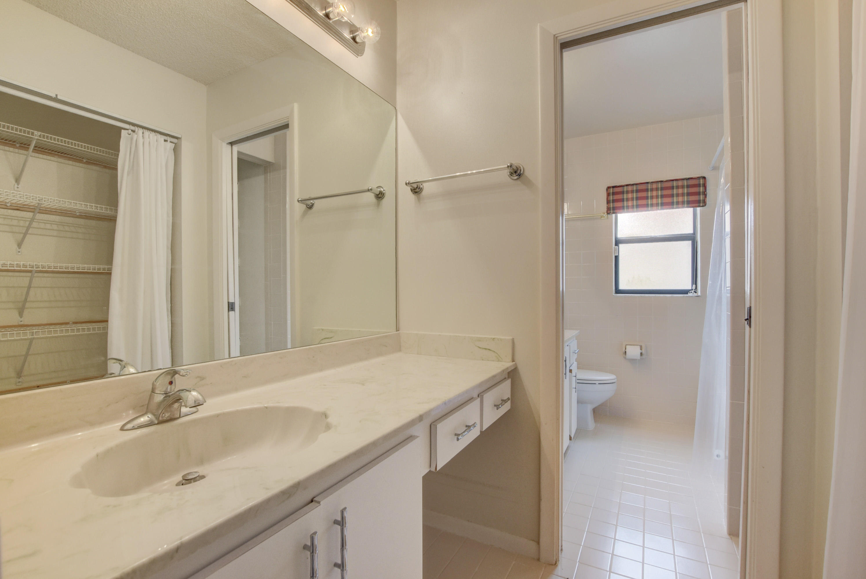 569 Southwest 28th Avenue Delray Beach, FL 33445 - Photo 11 of 25 a bathroom with a sink a toilet and shower