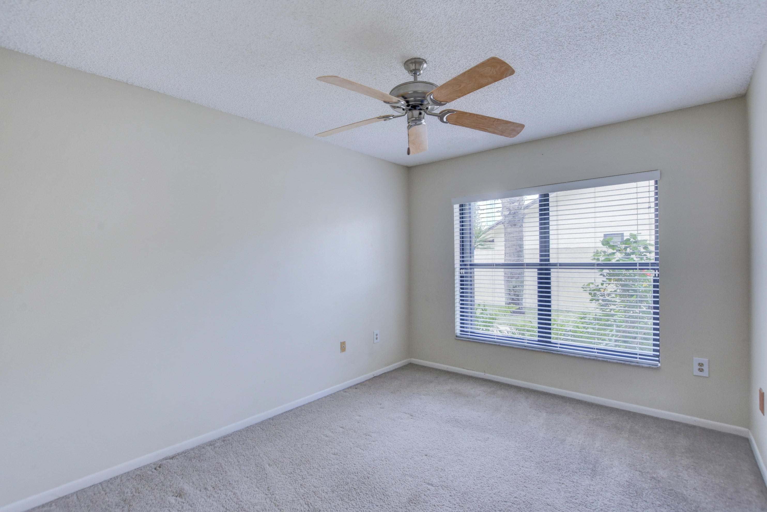569 Southwest 28th Avenue Delray Beach, FL 33445 - Photo 14 of 25 an empty room with windows and fan