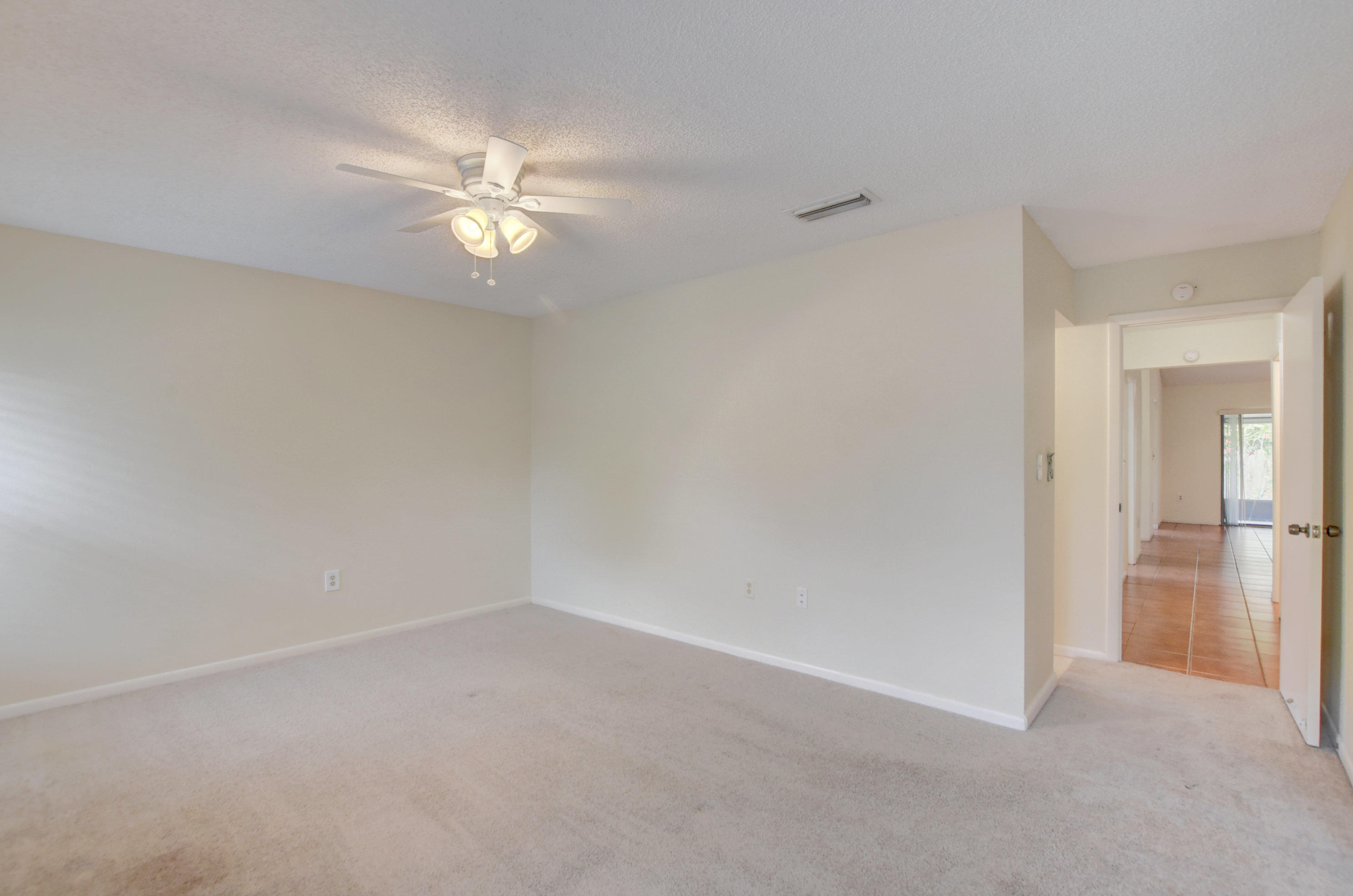 569 Southwest 28th Avenue Delray Beach, FL 33445 - Photo 15 of 25 an empty room with closet and a chandelier fan