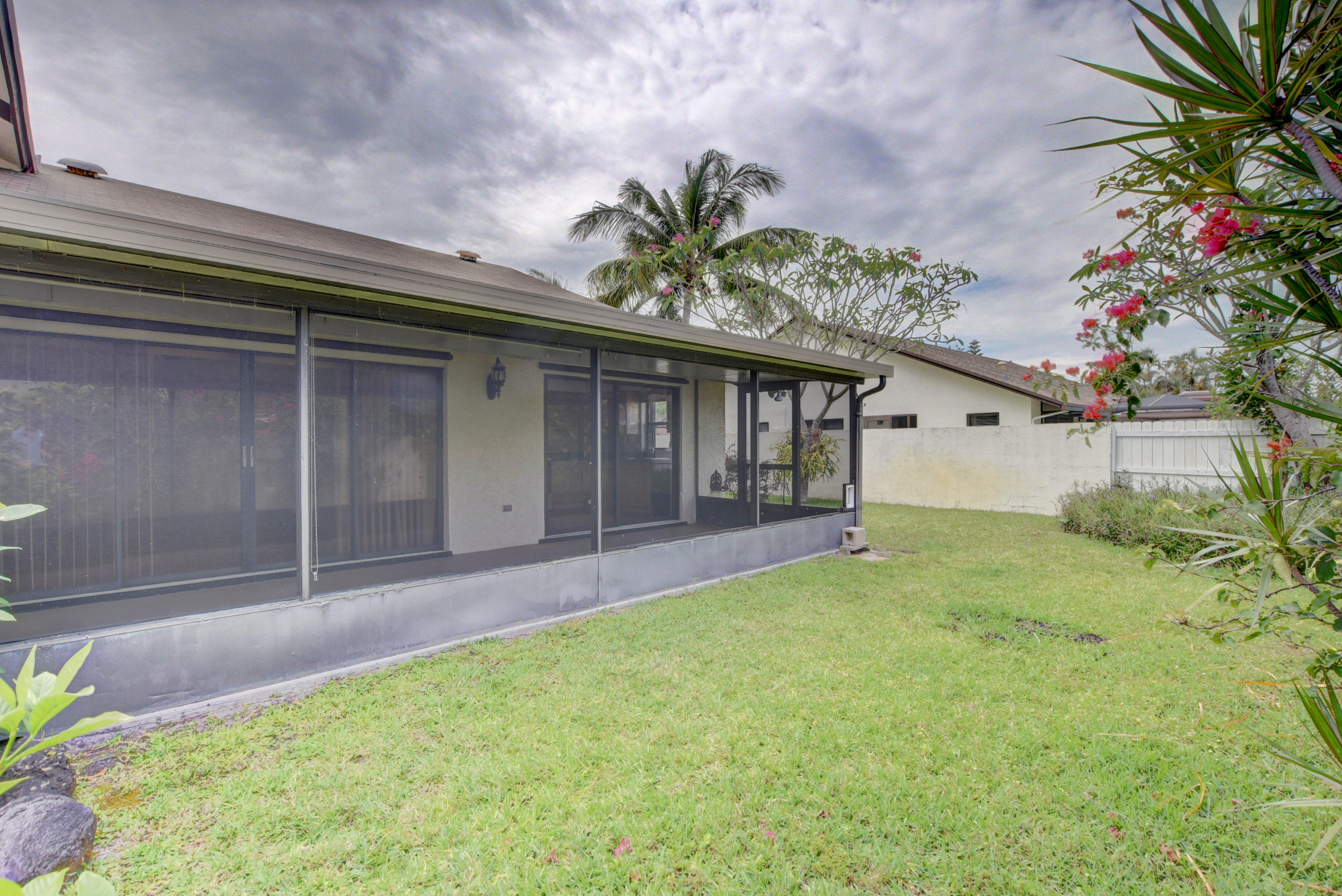 569 Southwest 28th Avenue Delray Beach, FL 33445 - Photo 20 of 25 a porch with a table and chairs in patio