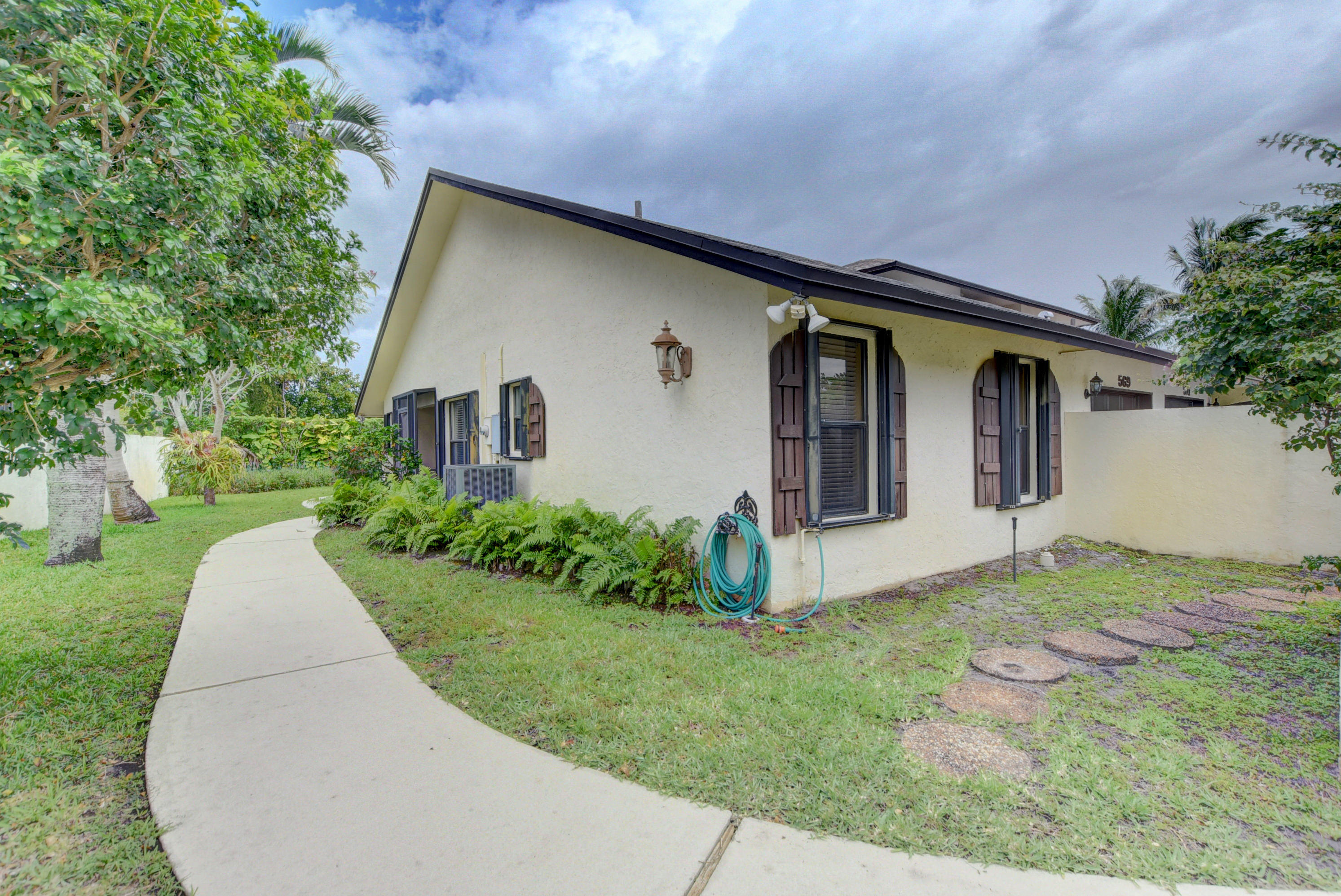 569 Southwest 28th Avenue Delray Beach, FL 33445 - Photo 23 of 25 a front view of house with yard