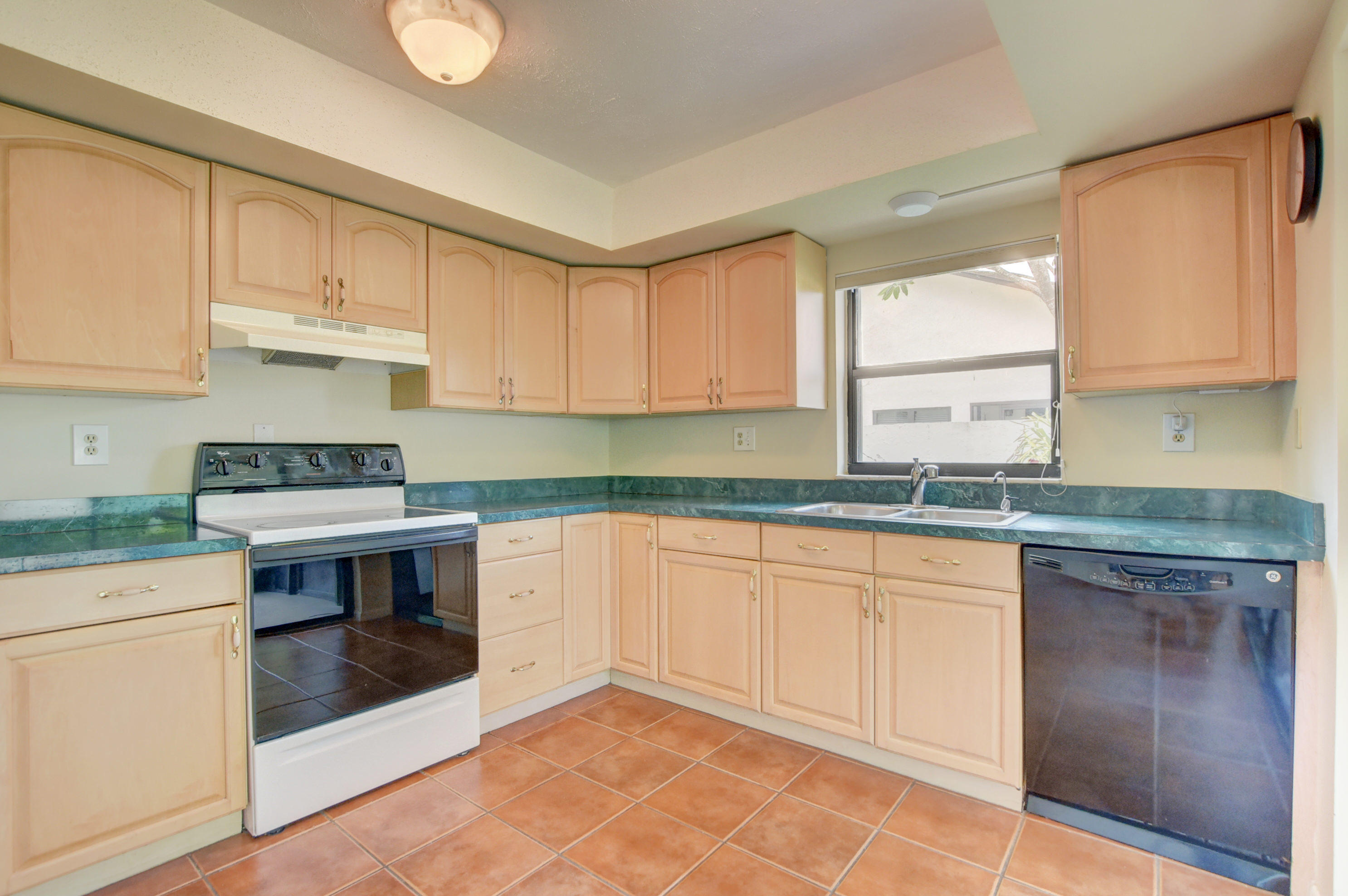 569 Southwest 28th Avenue Delray Beach, FL 33445 - Photo 8 of 25 a kitchen with stainless steel appliances granite countertop a stove a sink and a white cabinets