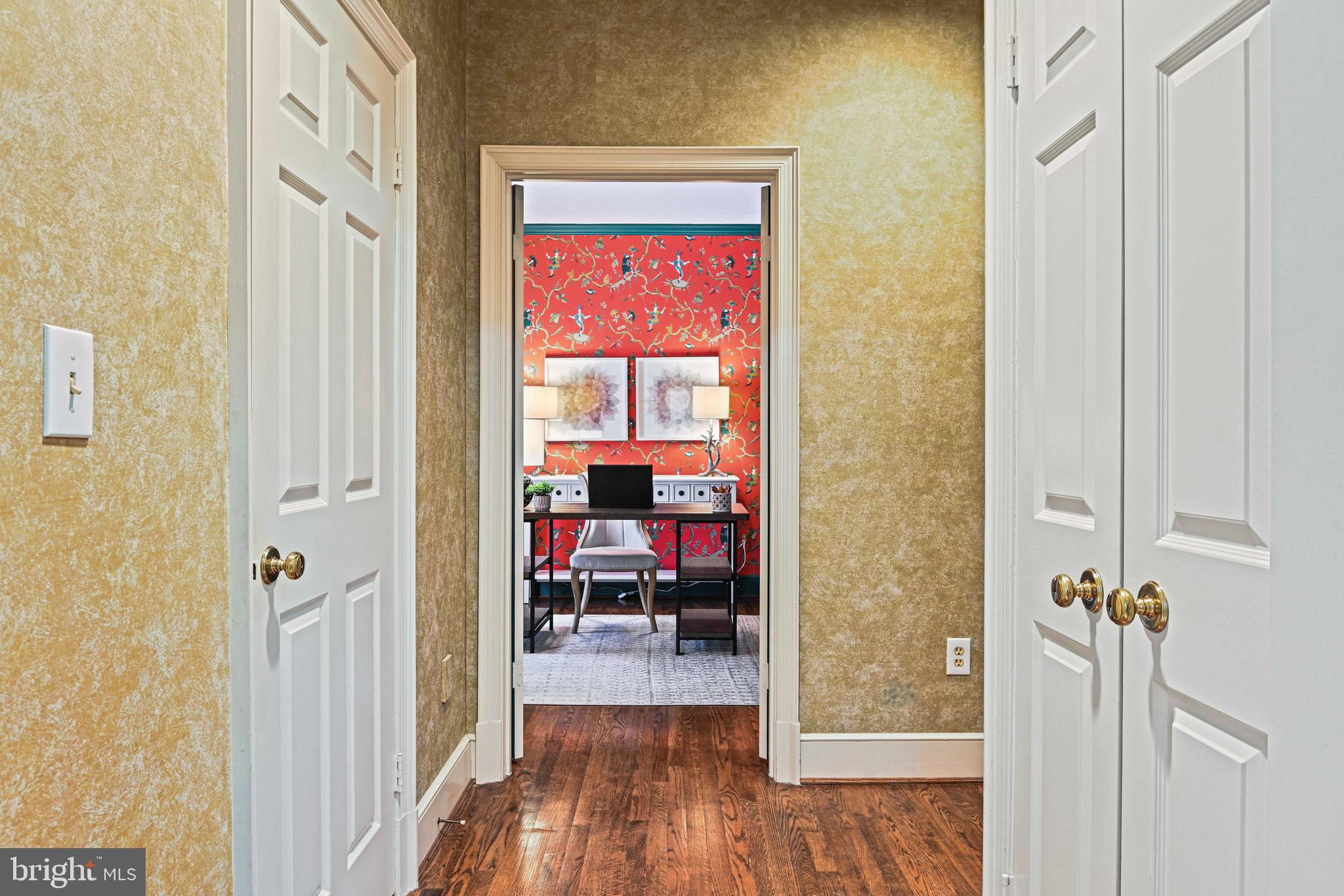 735 Potomac River Road McLean, VA 22102 - Photo 37 of 126 a view of a hallway with a room that has a bed and a bookshelf with wooden floor