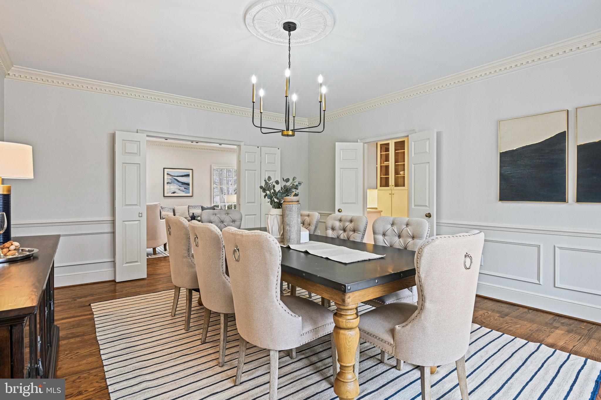 735 Potomac River Road McLean, VA 22102 - Photo 45 of 126 a dining room with wooden floor a chandelier a glass table and chairs