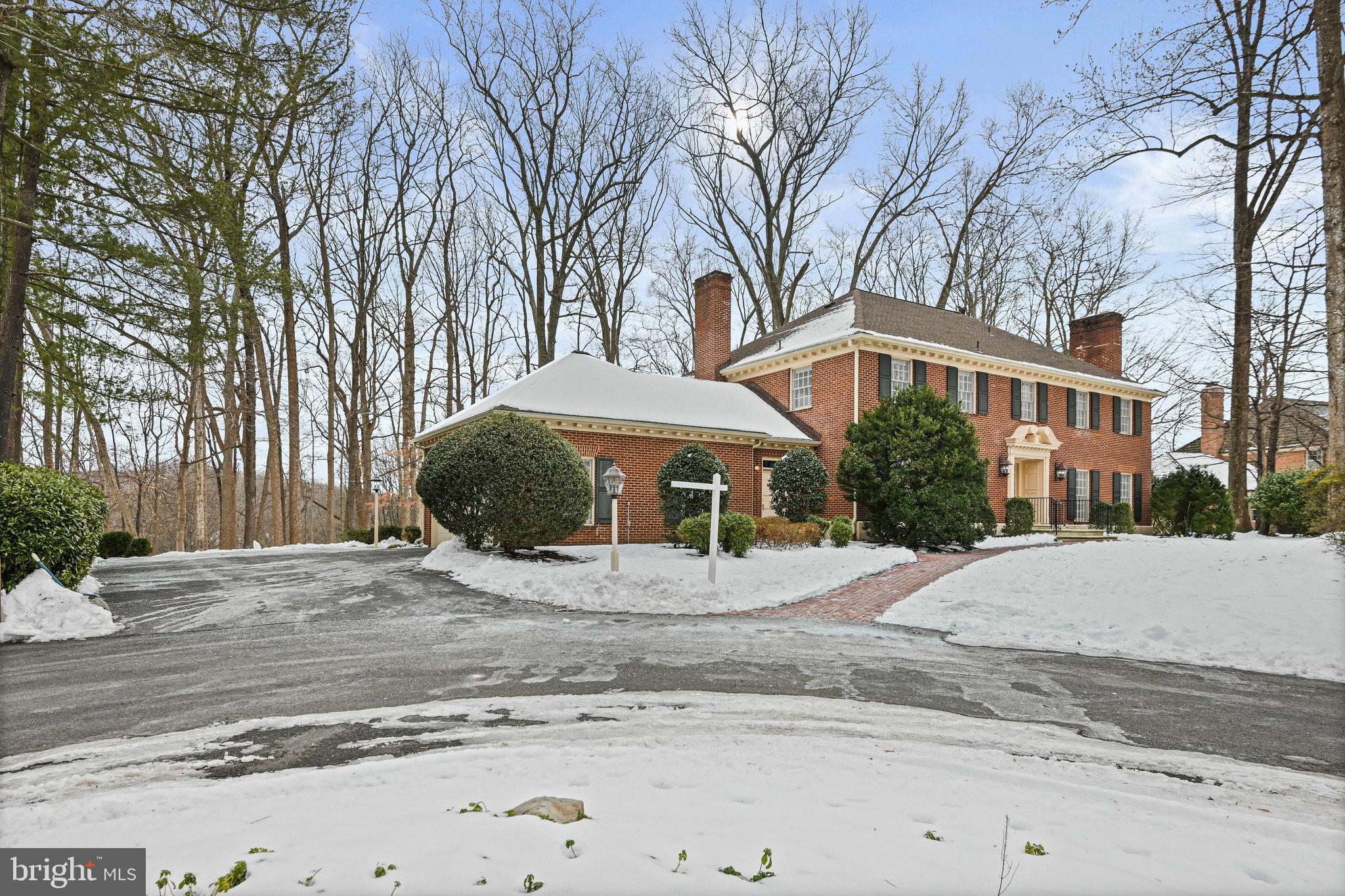 735 Potomac River Road McLean, VA 22102 - Photo 99 of 126 a front view of a house with a yard covered with trees