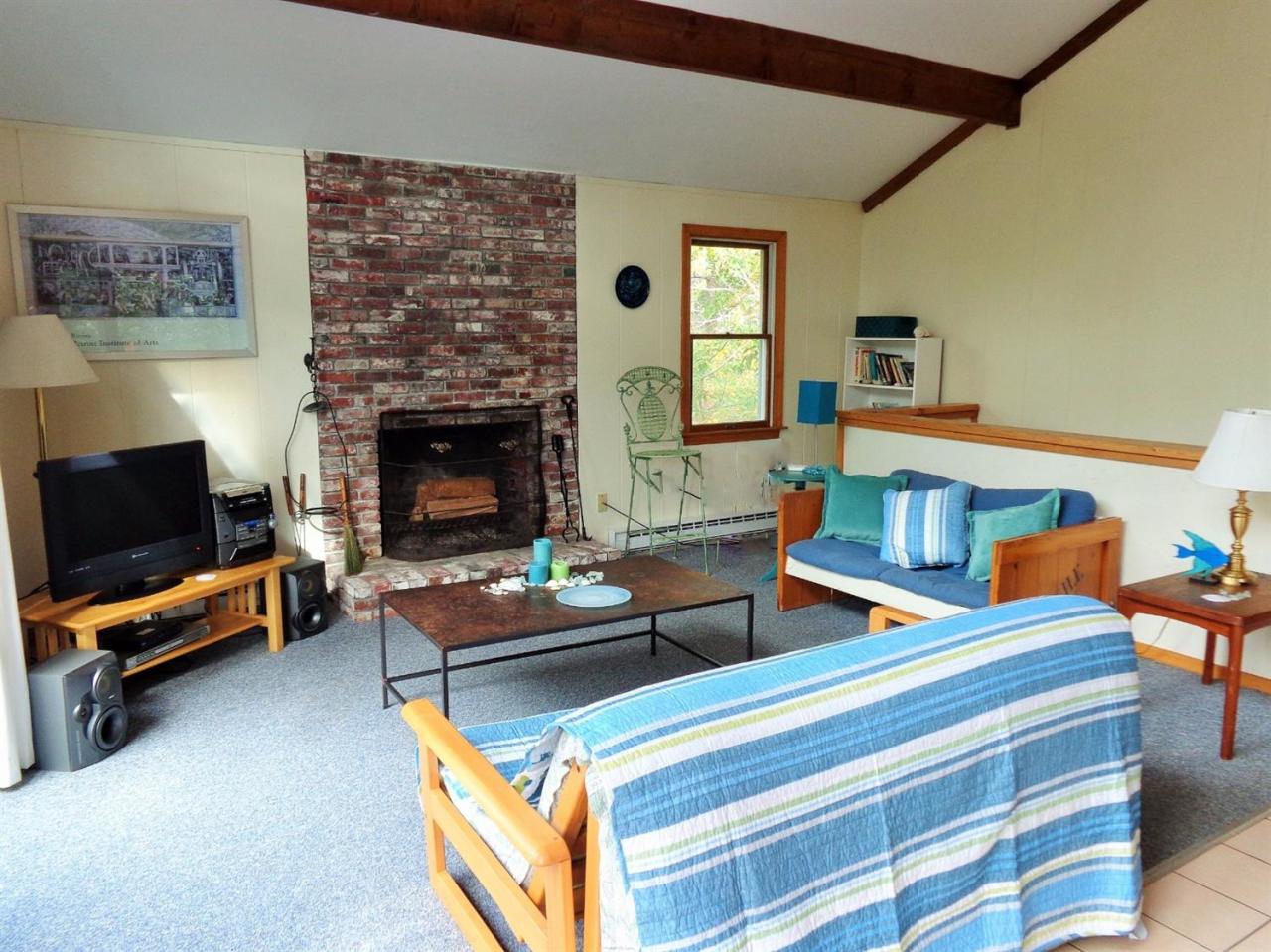 150 Cove View Road Wellfleet, MA 02667 - Photo 11 of 35 a living room with furniture and a fireplace
