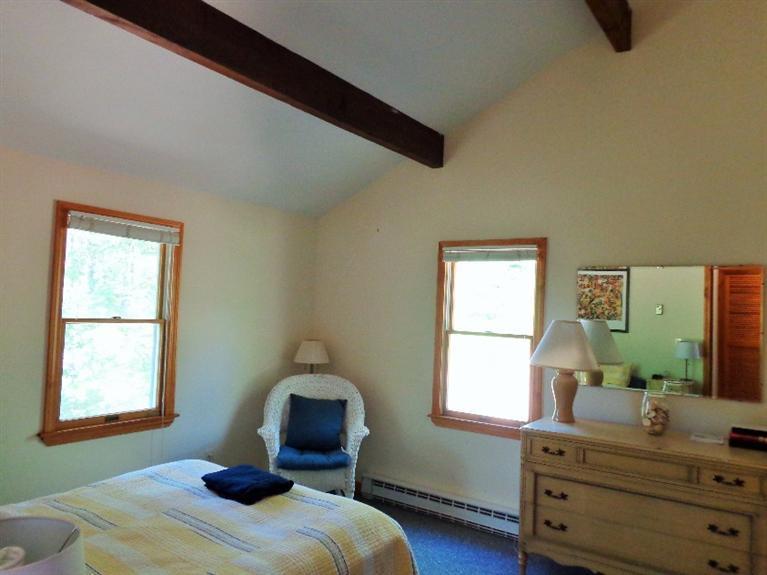 150 Cove View Road Wellfleet, MA 02667 - Photo 15 of 35 a bedroom with a bed and a window