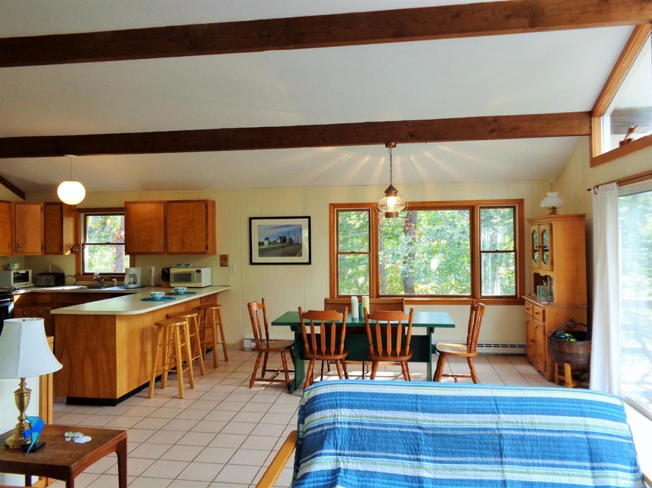 150 Cove View Road Wellfleet, MA 02667 - Photo 6 of 35 a living room with furniture a rug and a large window