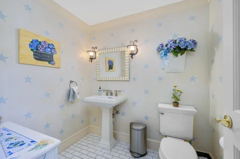 a bathroom with a granite countertop toilet sink and mirror