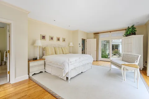 a living room with furniture and a dining table
