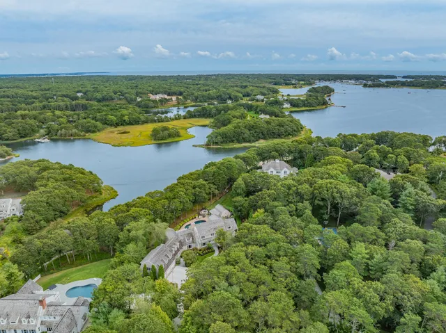 a front view of a house with a yard fire pit and outdoor seating