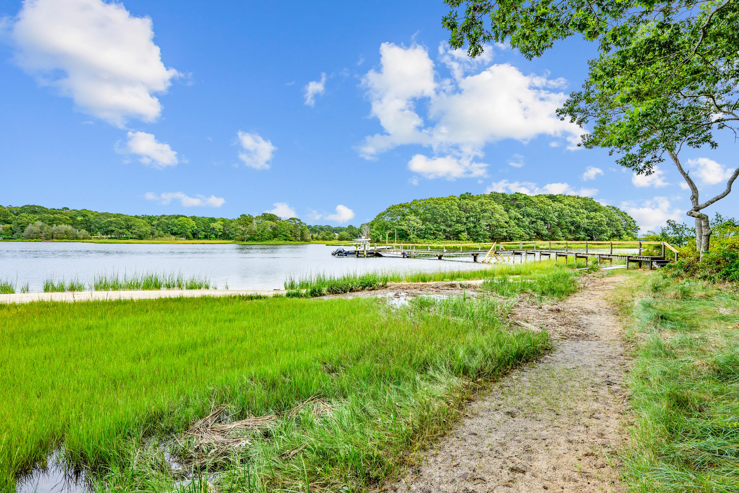 359 Baxter Neck Road Marstons Mills, MA 02648 - Photo 79 of 100 a view of a lake with a building in the background