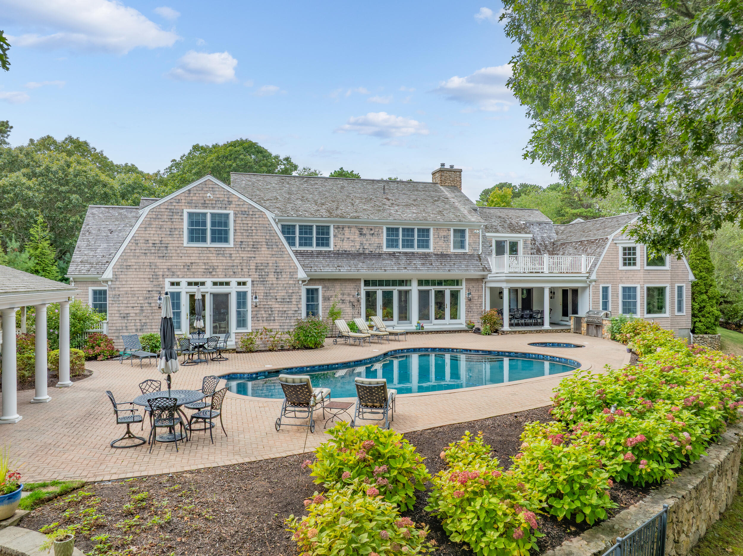 359 Baxter Neck Road Marstons Mills, MA 02648 - Photo 92 of 100 a front view of a house with a garden and swimming pool