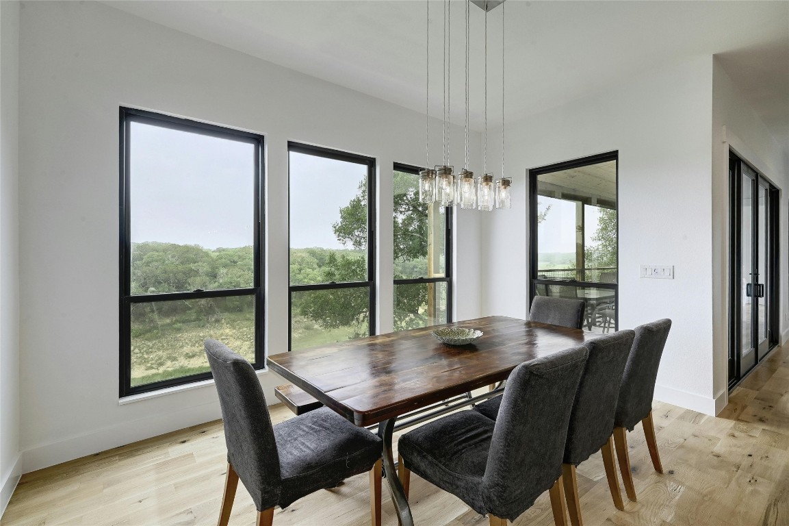 26701 Blue Cove Road Marble Falls, TX 78654 - Photo 10 of 27 a view of a dining room with furniture window and wooden floor