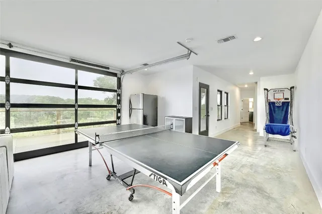 a room with pool table and windows