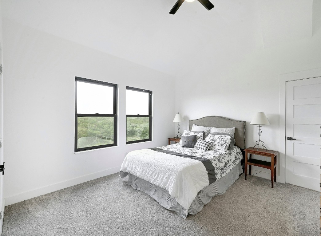 26701 Blue Cove Road Marble Falls, TX 78654 - Photo 18 of 27 a bedroom with a bed a table and windows