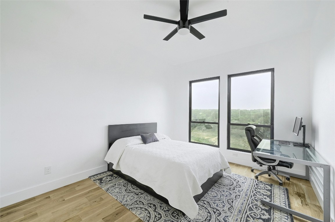 26701 Blue Cove Road Marble Falls, TX 78654 - Photo 19 of 27 a bedroom with a bed and a large window