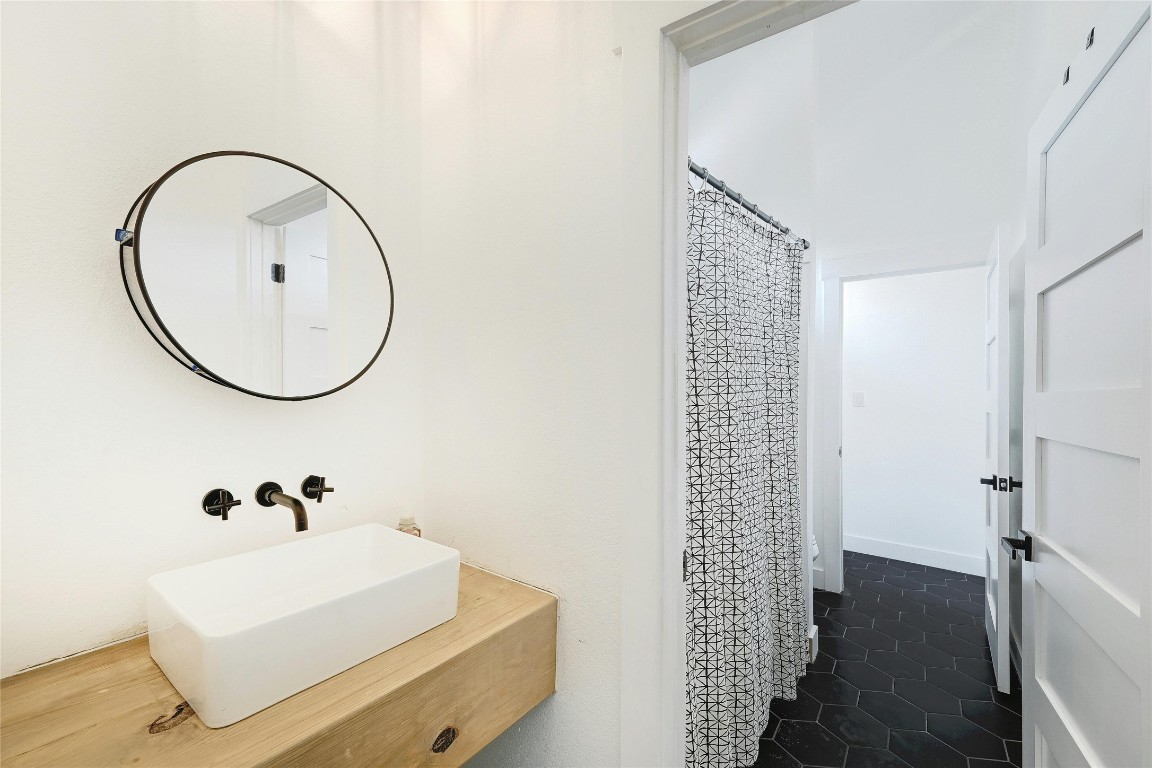 26701 Blue Cove Road Marble Falls, TX 78654 - Photo 21 of 27 a bathroom with a sink a mirror and a shower