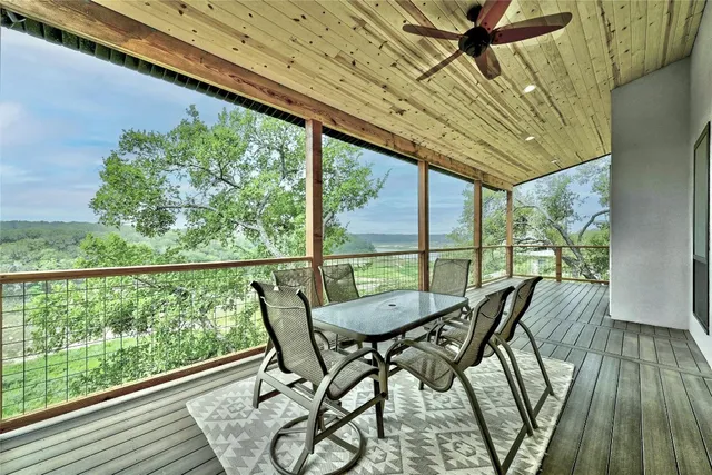 a view of a balcony with furniture and wooden floor