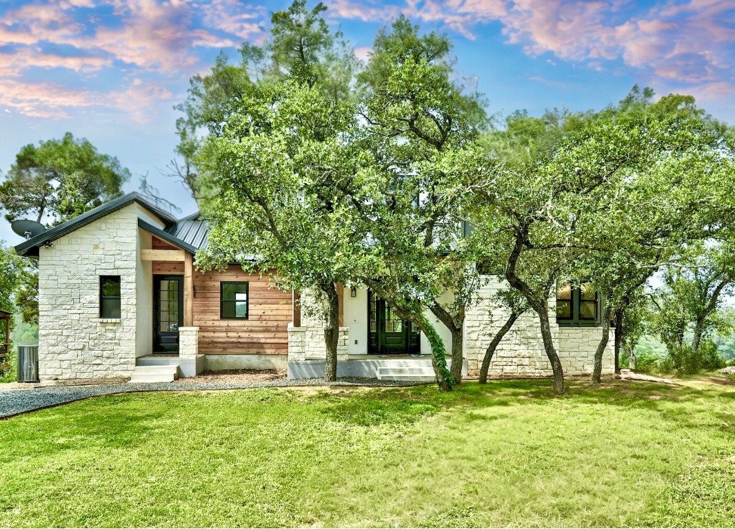 26701 Blue Cove Road Marble Falls, TX 78654 - Photo 6 of 27 a front view of a house with a garden