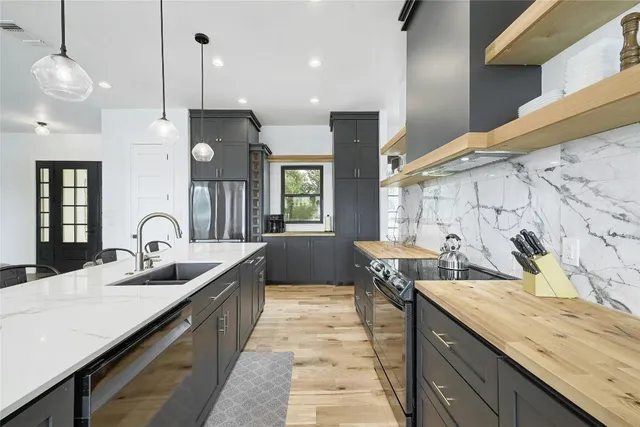 a kitchen with counter space a sink and a stove