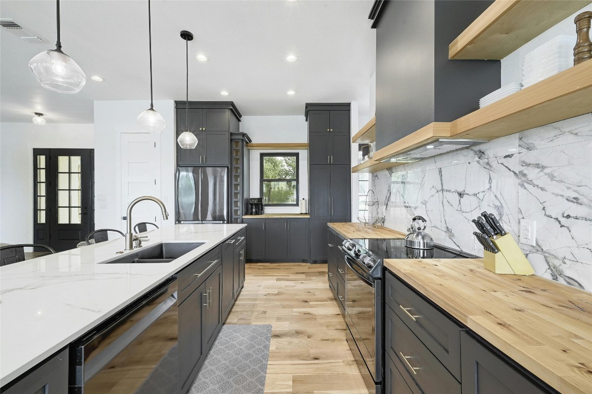 26701 Blue Cove Road Marble Falls, TX 78654 - Photo 7 of 27 a kitchen with counter space a sink and a stove