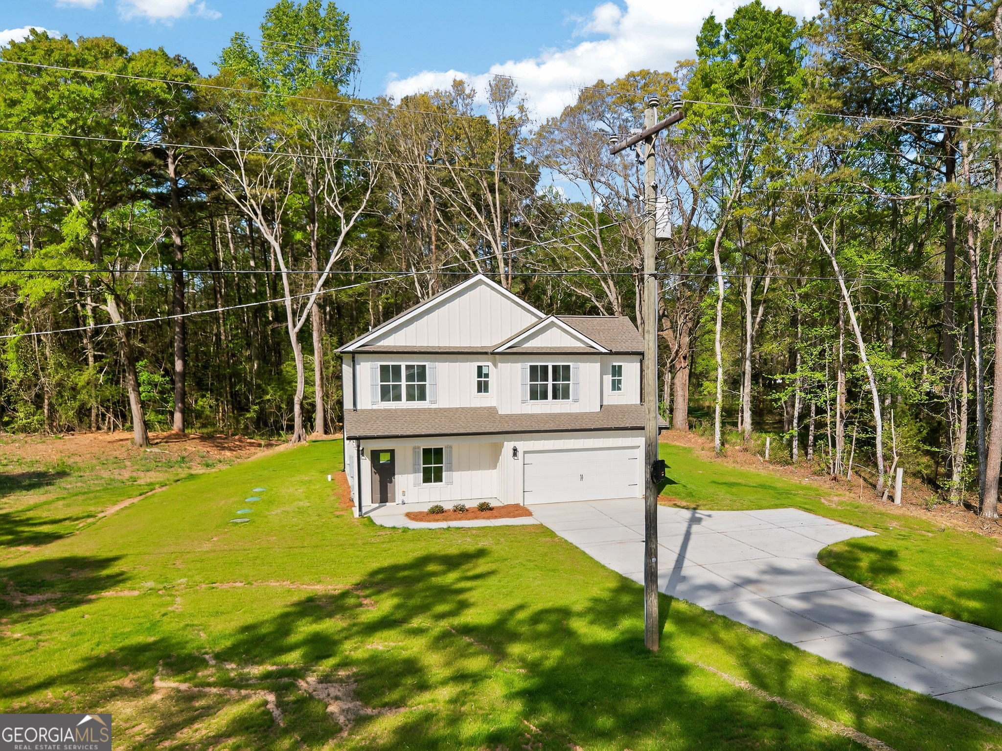 1229 Chappell Mill Road Jackson, GA 30233 - Photo 17 of 55 a front view of a house with a yard table and chairs