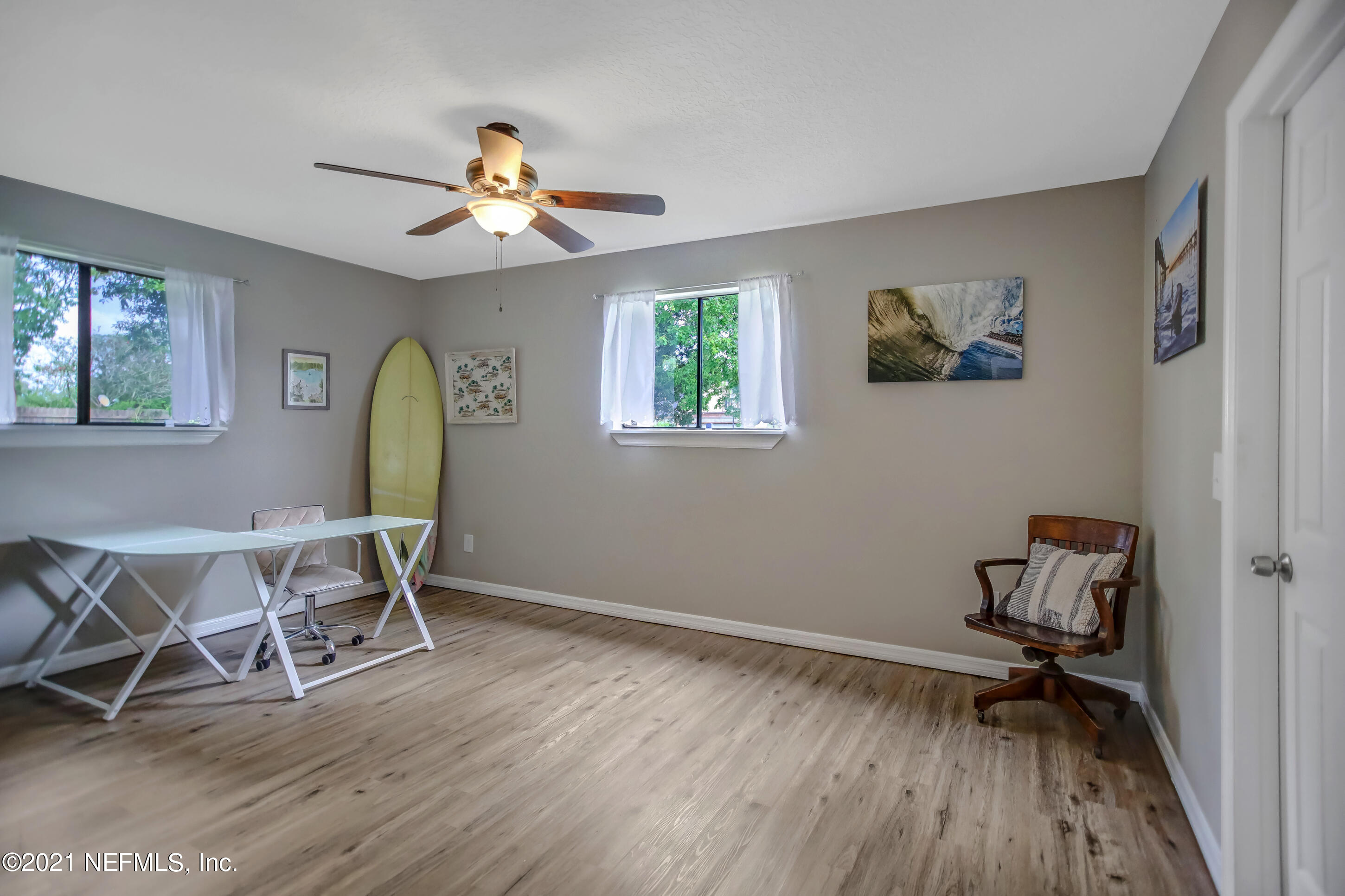 2587 Summer Tree Road East Jacksonville, FL 32246 - Photo 16 of 58 a view of a workspace with wooden floor a chandelier fan and windows