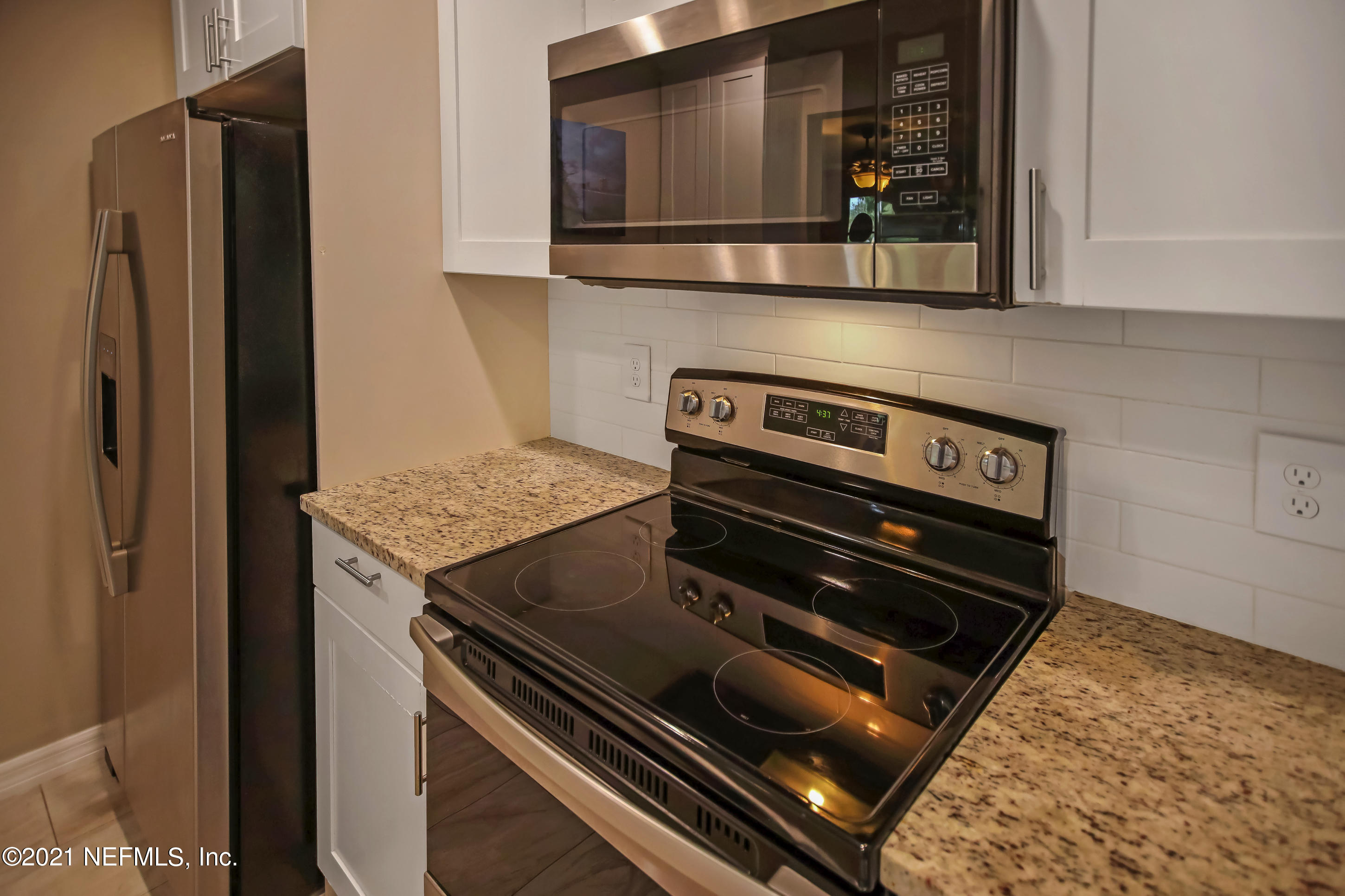 2587 Summer Tree Road East Jacksonville, FL 32246 - Photo 26 of 58 a stove top oven sitting inside of a kitchen