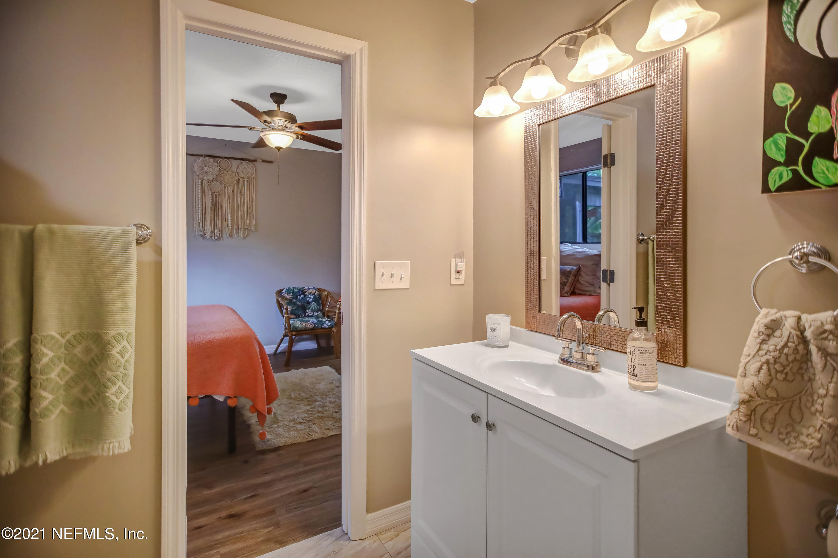 2587 Summer Tree Road East Jacksonville, FL 32246 - Photo 30 of 58 a en suite bathroom with a sink and mirror
