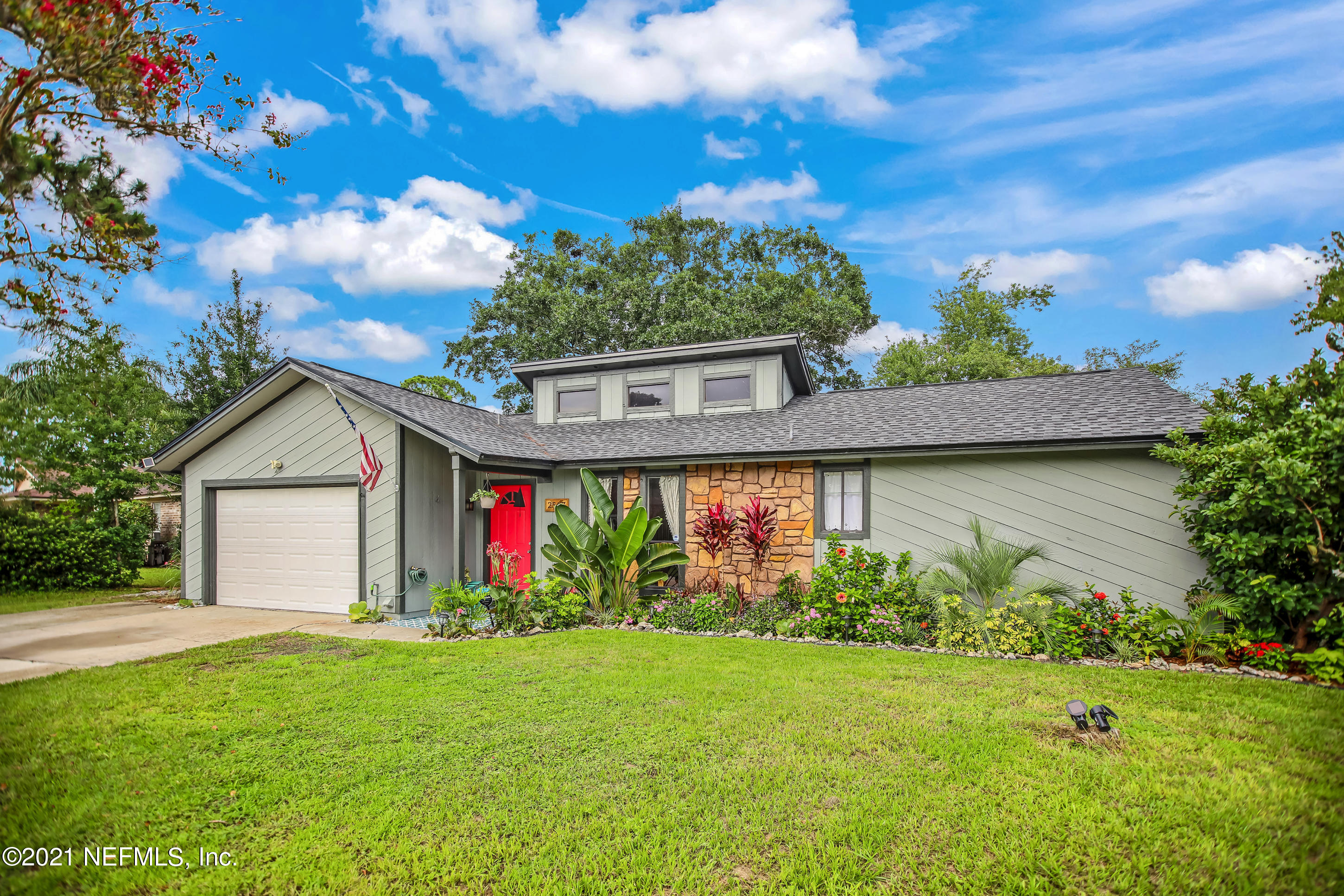 2587 Summer Tree Road East Jacksonville, FL 32246 - Photo 3 of 58 a front view of a house with a yard and garage