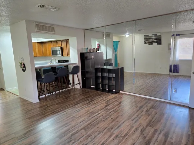 a view of a bedroom with wooden floor