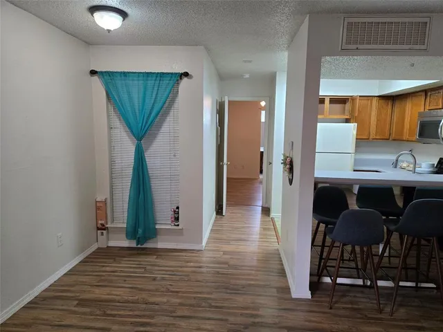 a kitchen with granite countertop a stove top oven microwave and cabinets