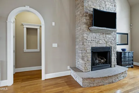 a living room with a fireplace and a flat screen tv