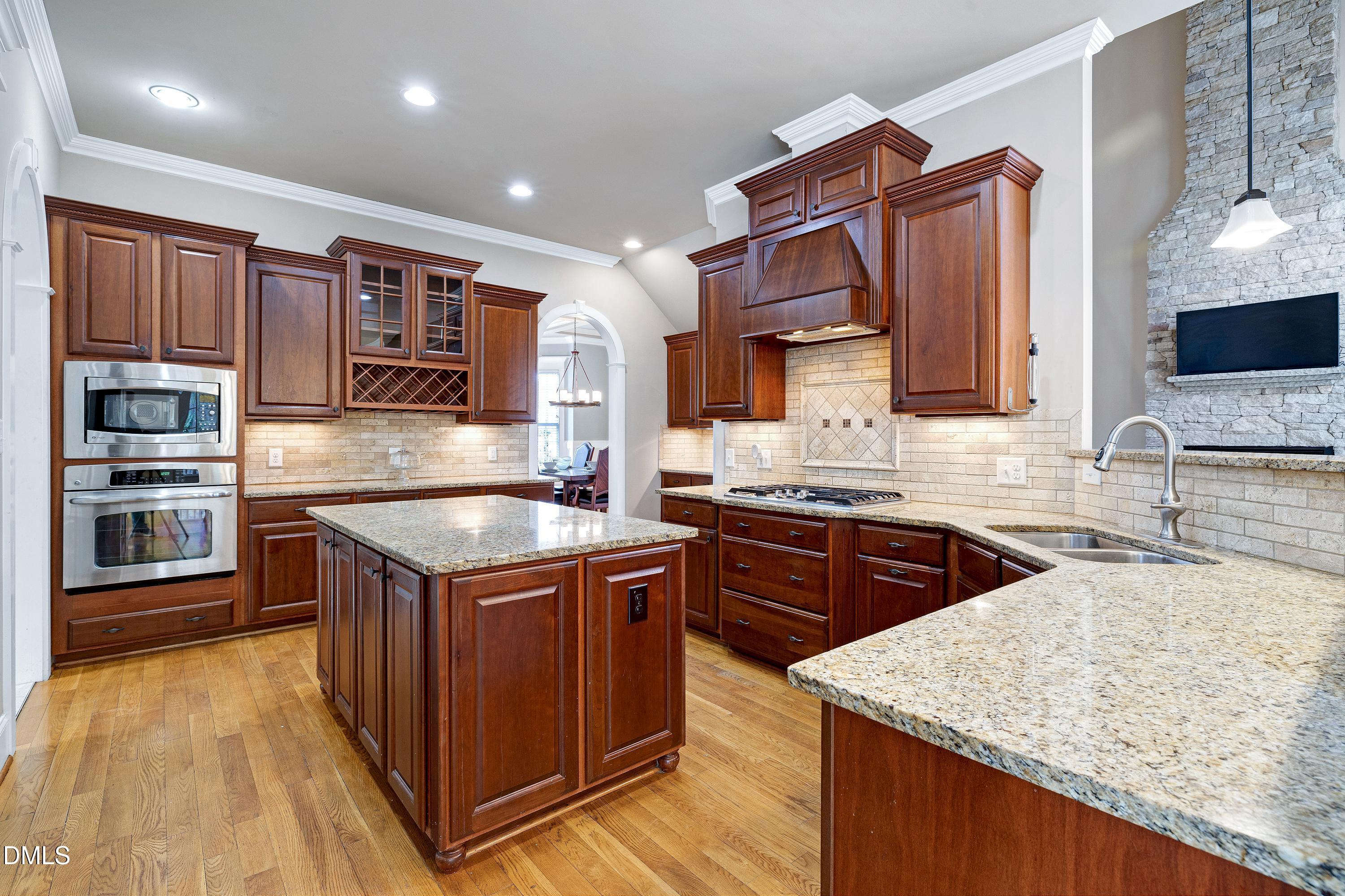 14212 Careme Court Wake Forest, NC 27587 - Photo 13 of 54 a kitchen with stainless steel appliances granite countertop a sink stove and refrigerator