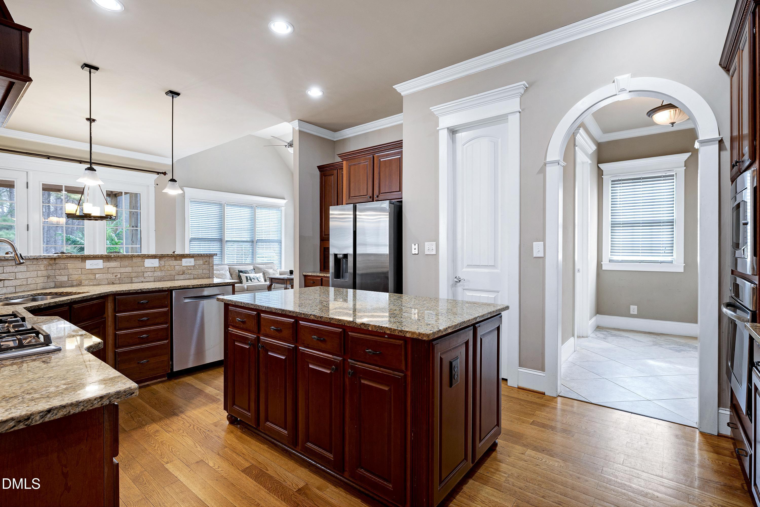 14212 Careme Court Wake Forest, NC 27587 - Photo 17 of 54 a kitchen with stainless steel appliances granite countertop counter space a sink and cabinets